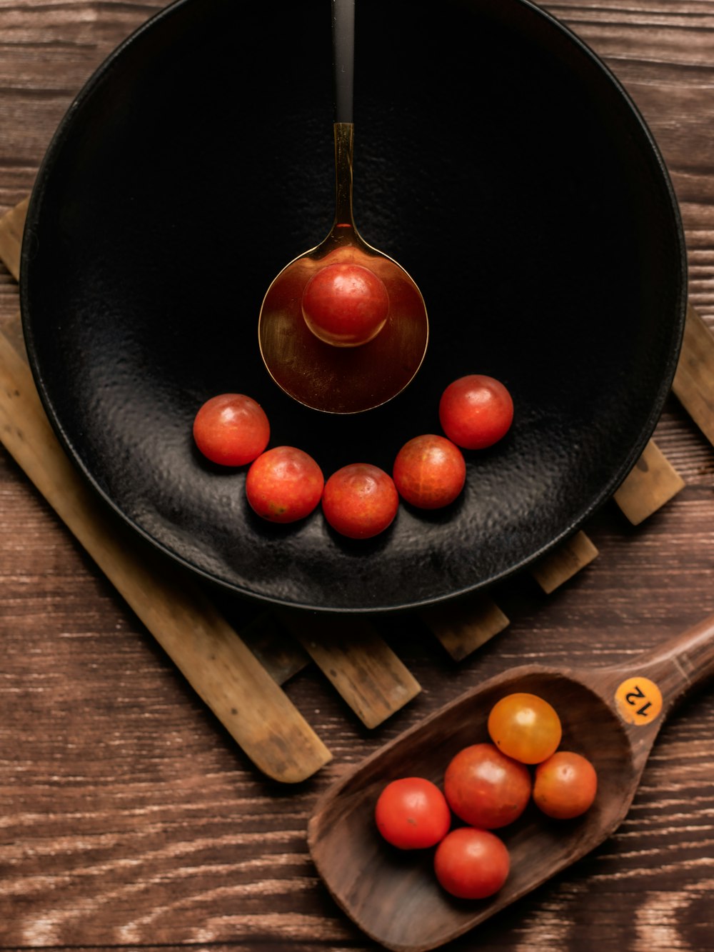 red tomato on black ceramic plate