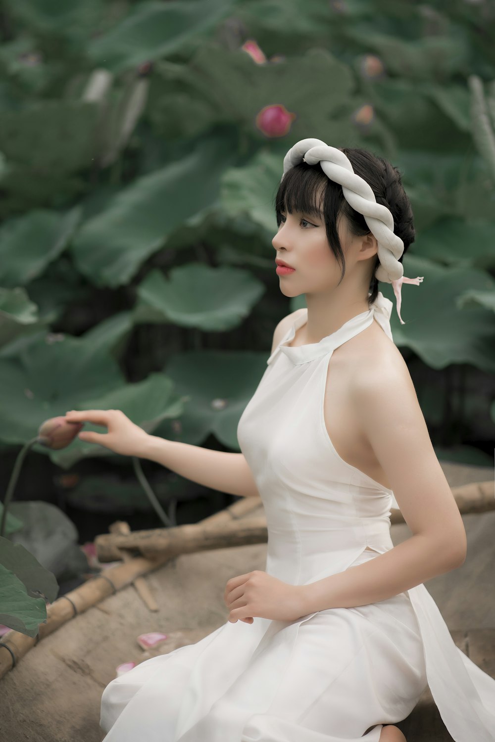 woman in white tank top standing and smiling