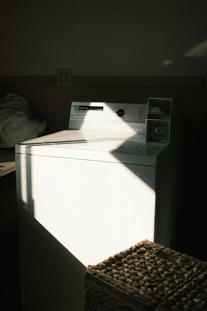 White top-load Kenmore-style washing machine in a home laundry room serviced by an Altoona appliance repair technician