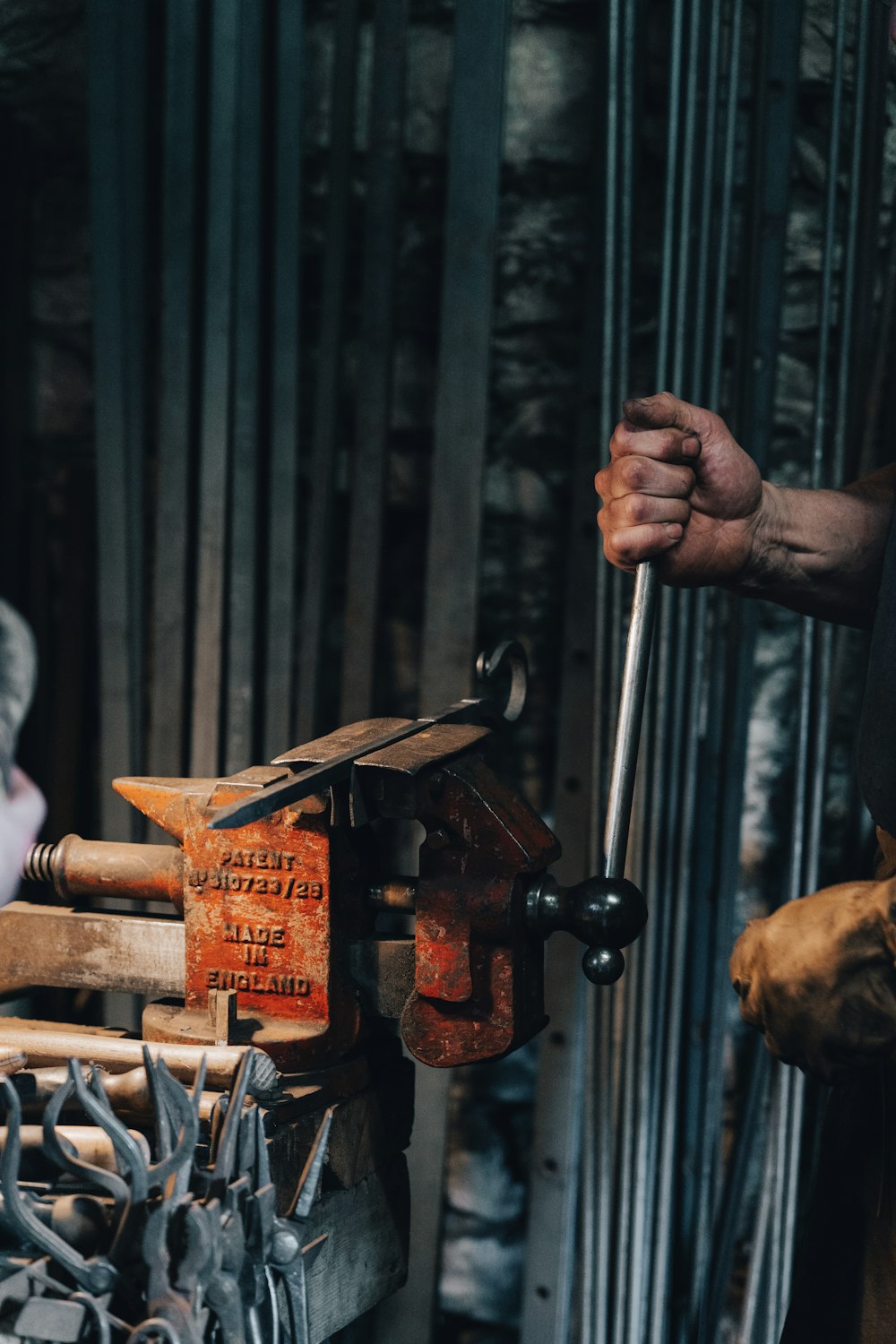 person holding brown wooden hand tool