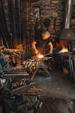 Artisan at work shaping metal products in a workshop setting