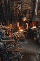 A blacksmith shaping metal in a traditional workshop with sparks flying.