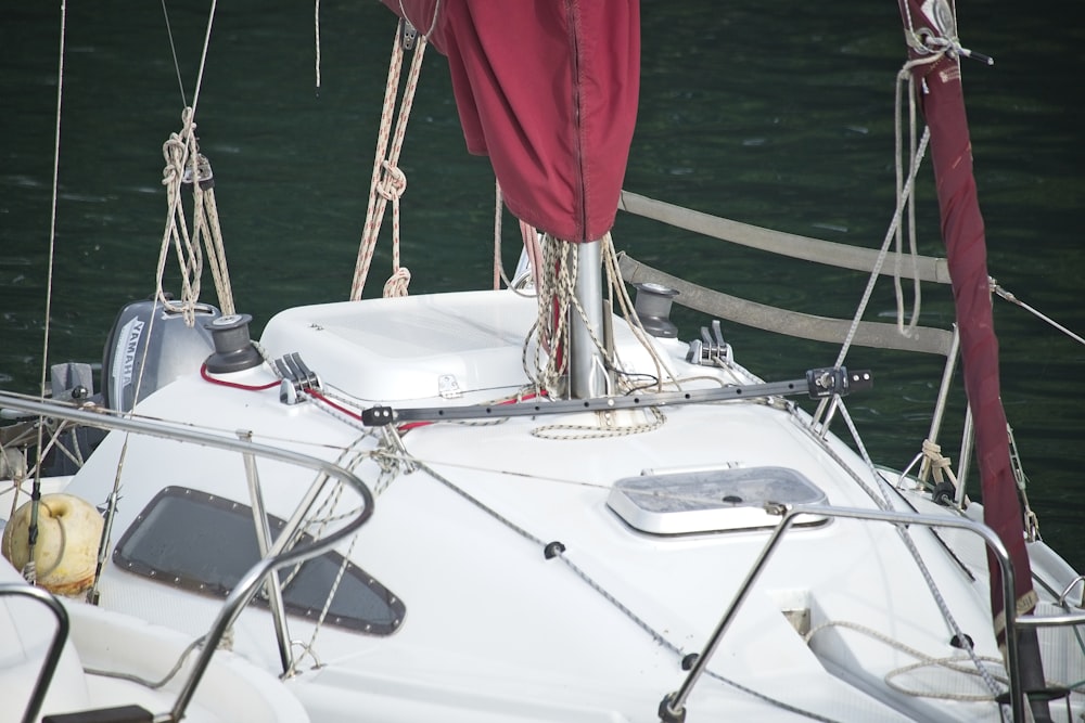 red textile on white boat during daytime