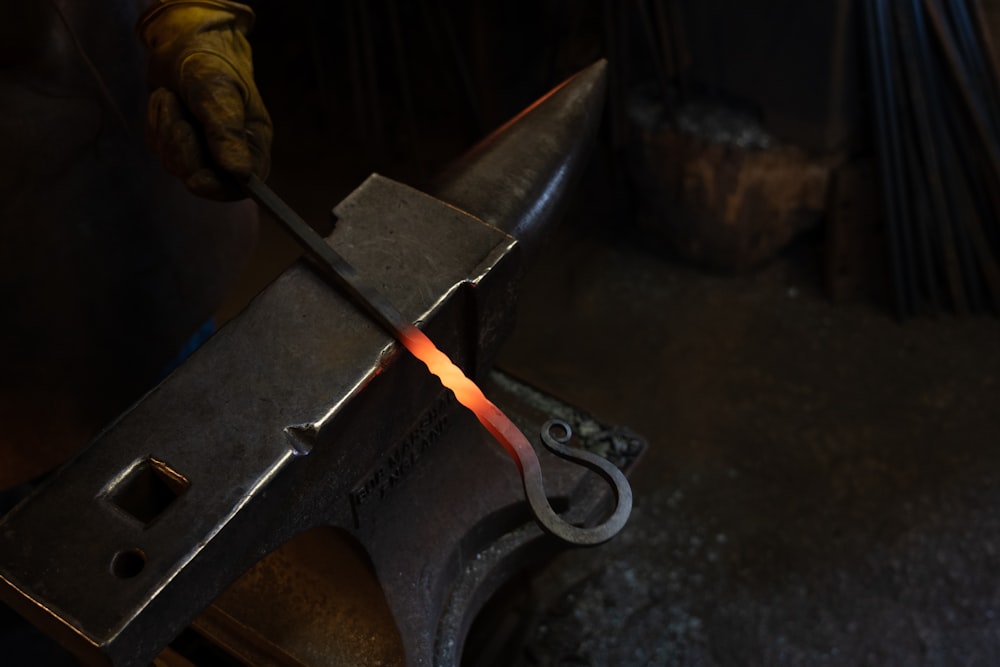 person holding black and silver sword