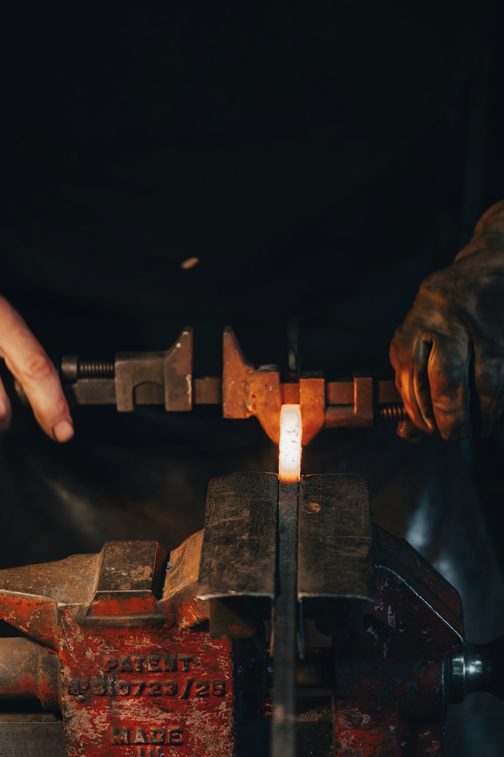 person holding brown metal tool