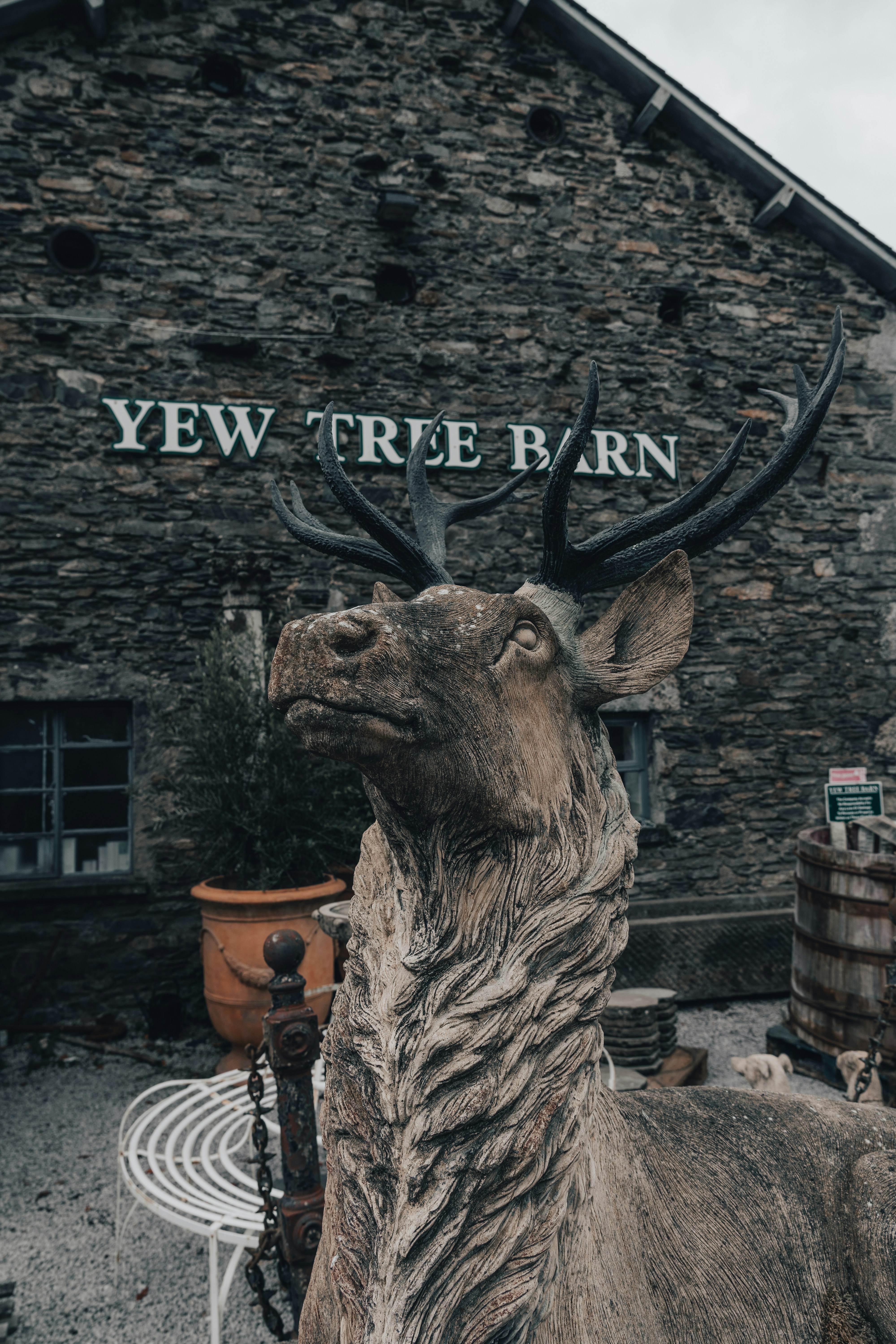 brown horse statue near brown brick wall