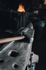 brown wooden handle hammer on black metal tool