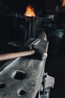 brown wooden handle hammer on black metal tool
