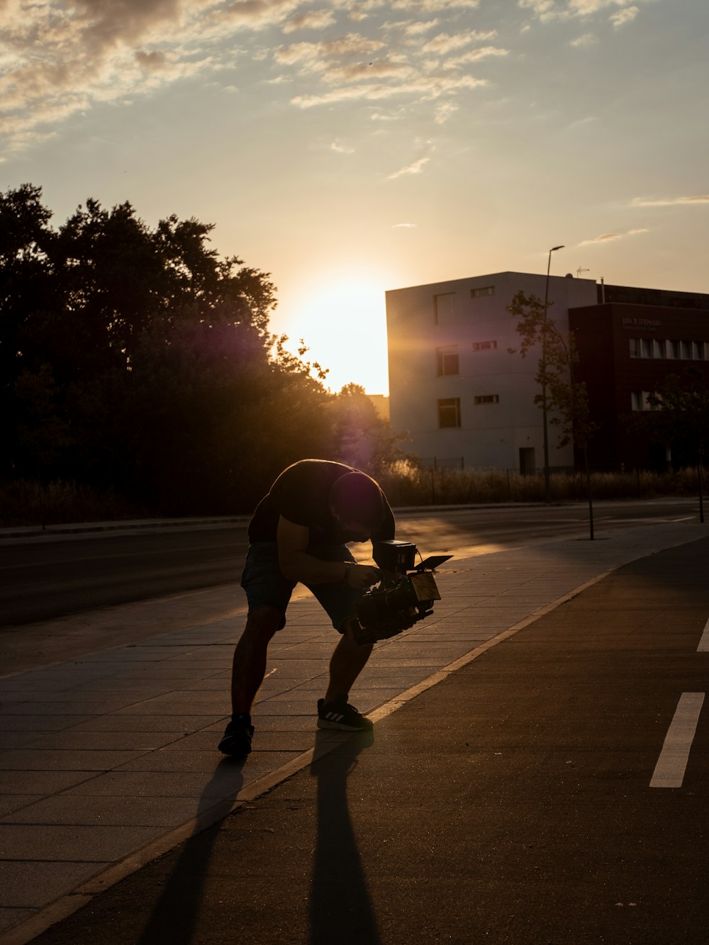 man in black jacket and pants riding on black skateboard on road during daytime