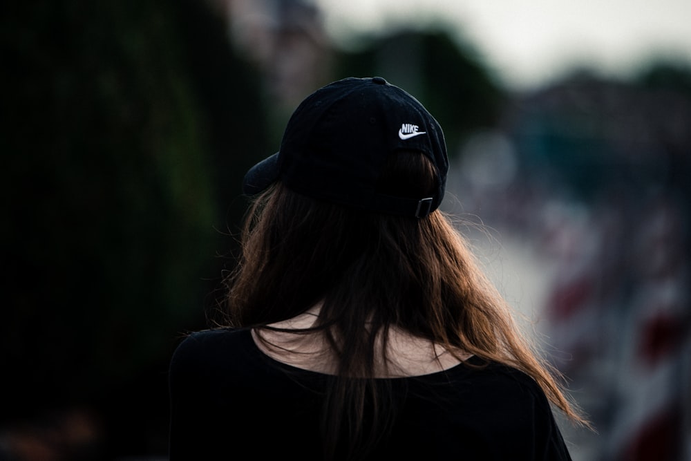 woman in black shirt wearing black cap