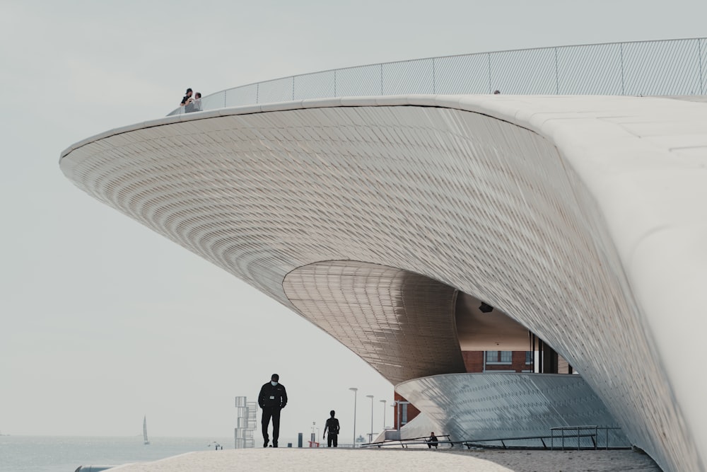 people walking on white concrete building during daytime