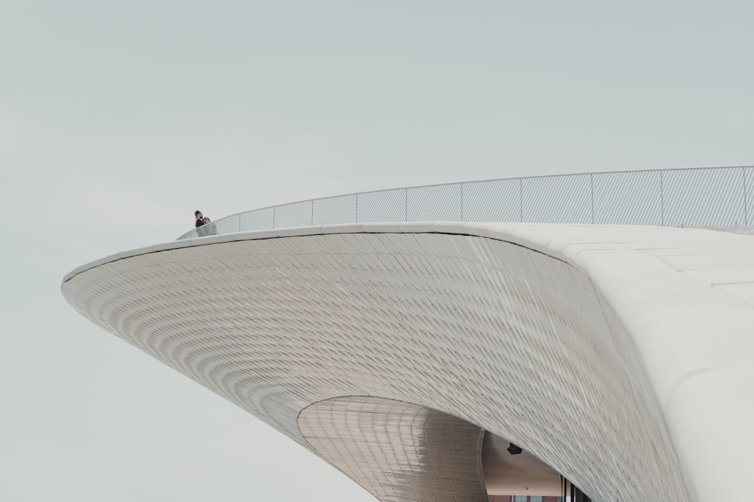 people walking on white concrete building during daytime