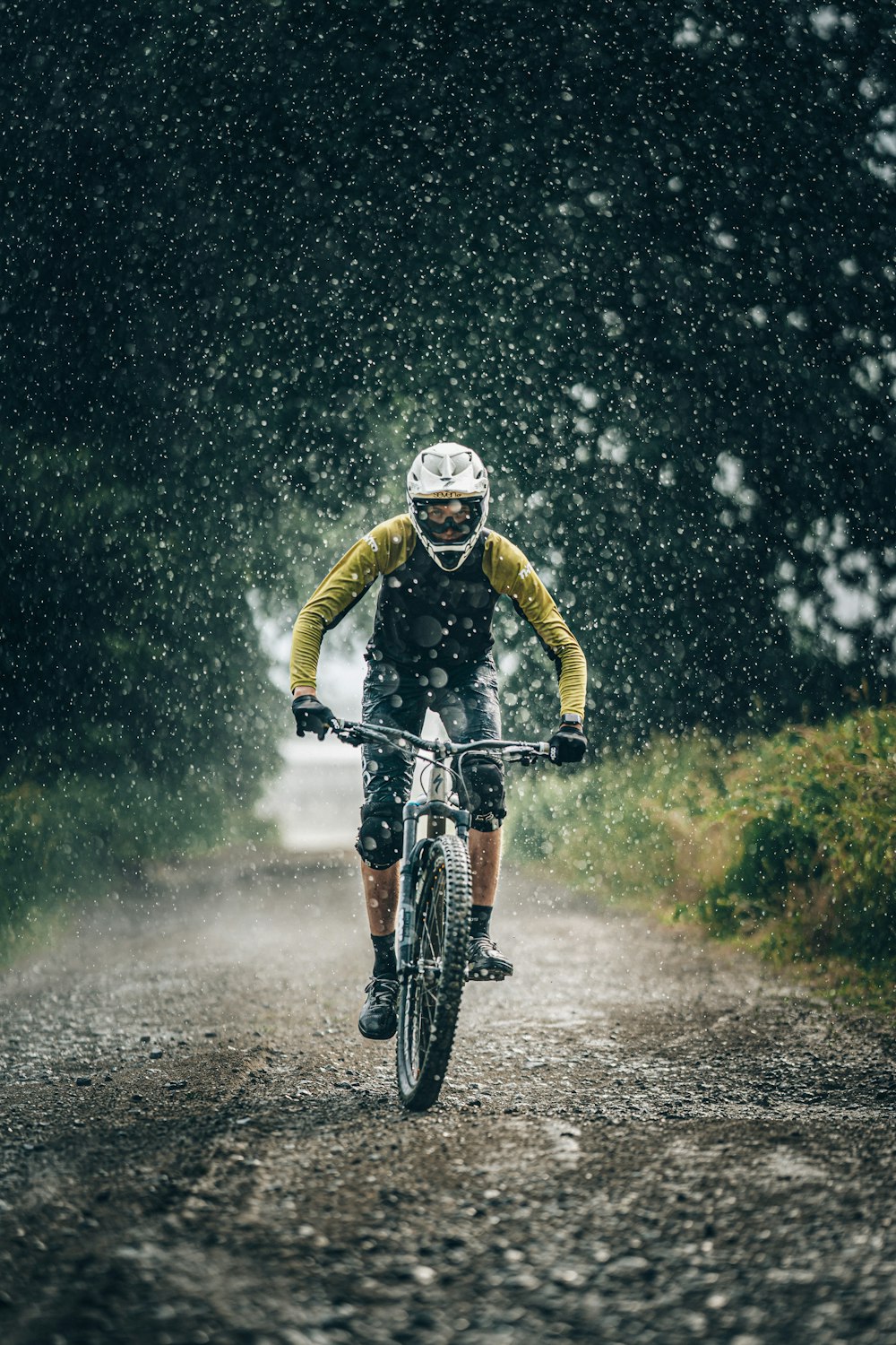 man in black jacket riding bicycle on road during daytime