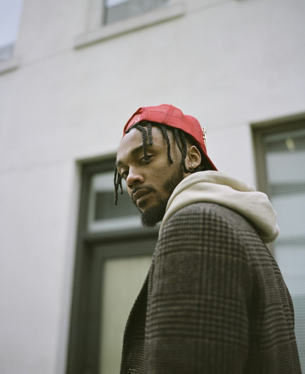 man in red knit cap and gray sweater