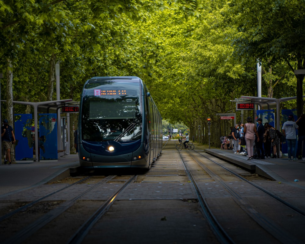 blue and white tram on road during daytime