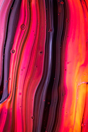 A vibrant healing symbol painted with flowing lines on textured canvas