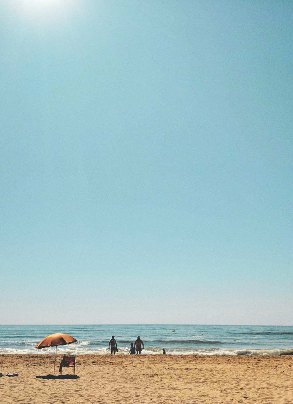 2 person lying on beach during daytime