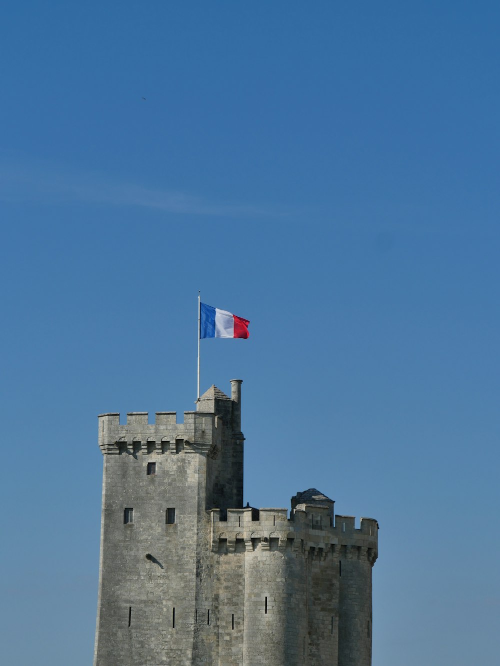 gray concrete castle with flag of us a on top under blue sky during daytime