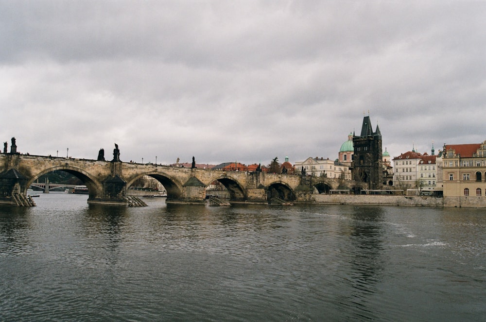 brown concrete bridge over river during daytime