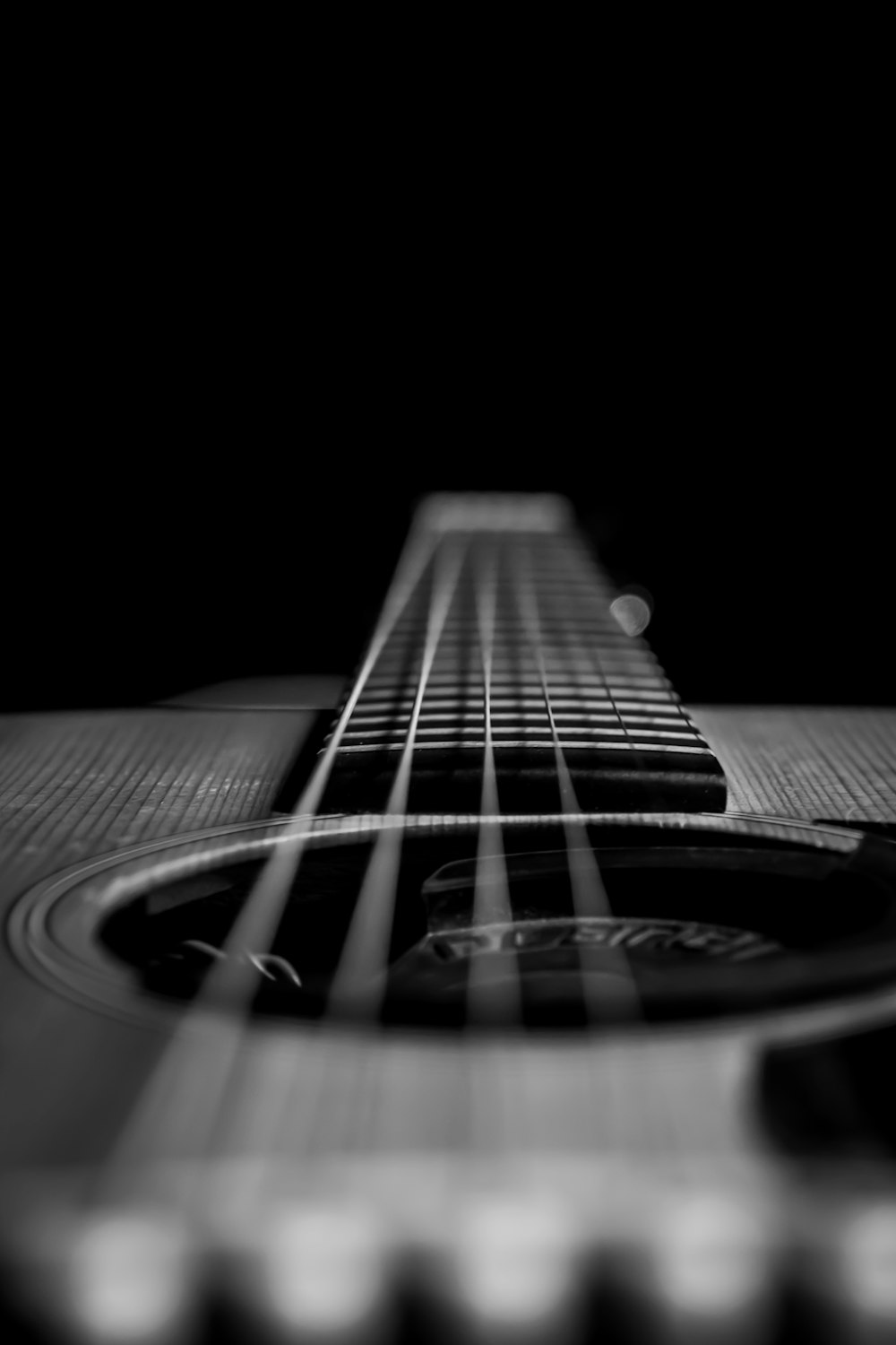 grayscale photo of acoustic guitar