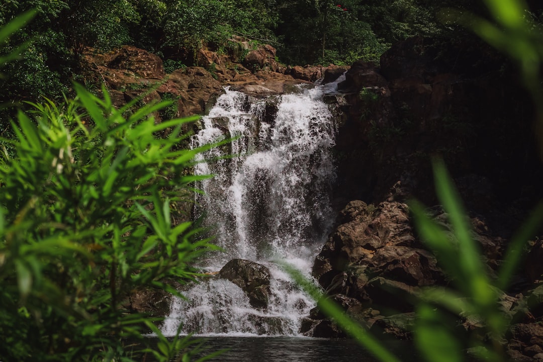 water falls on brown rocky mountain