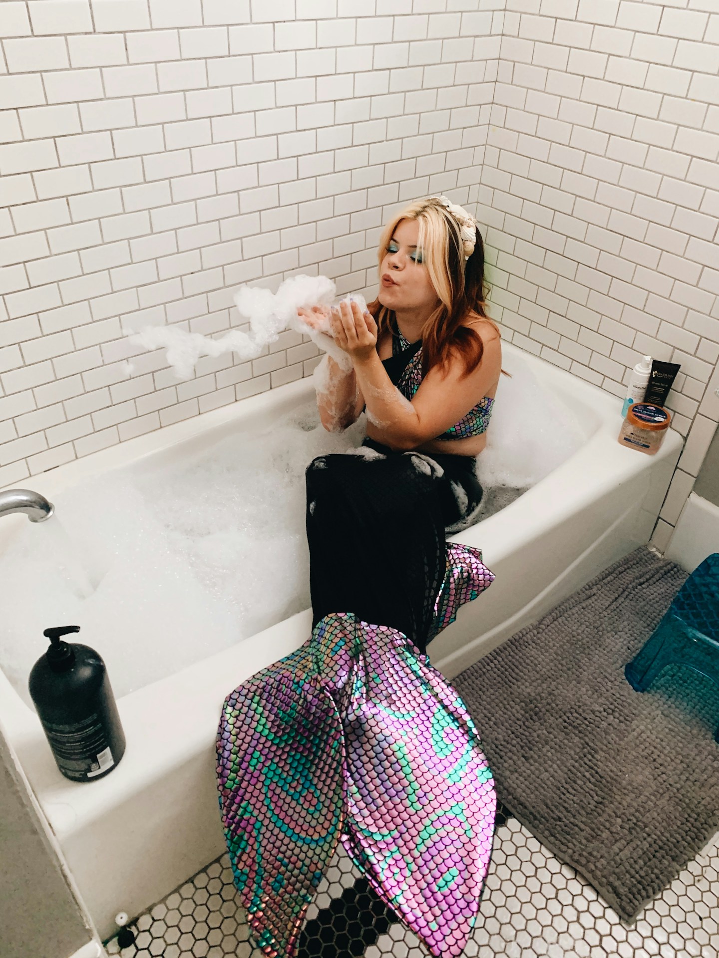 woman in black tank top and pink white plaid skirt sitting on bathtub