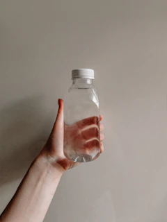 a hand holding a bottle