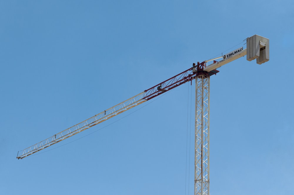 yellow crane under blue sky during daytime