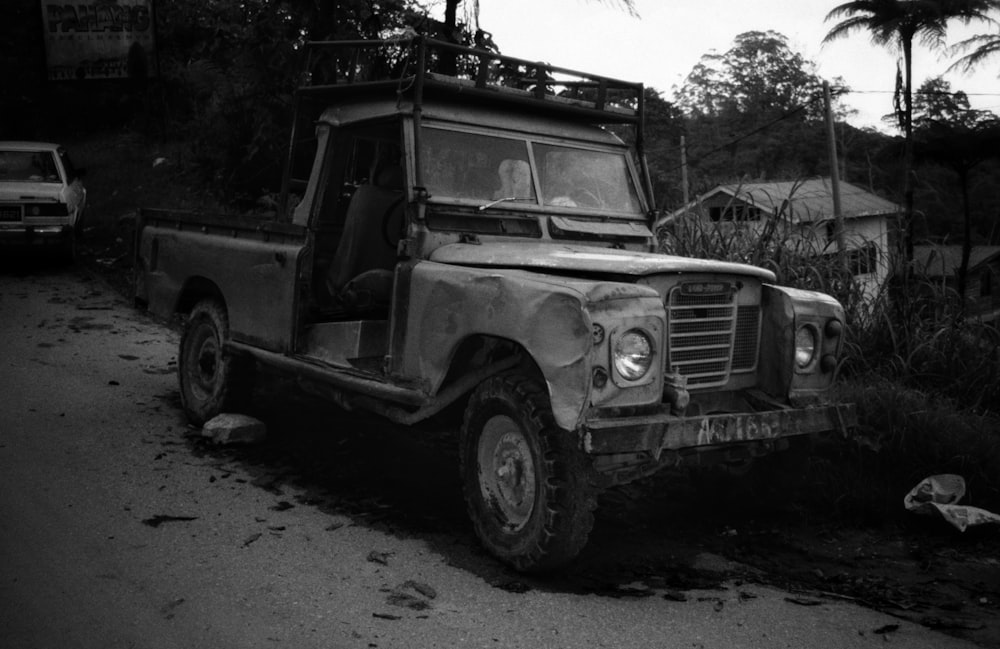 grayscale photo of suv on forest