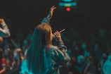 woman in black jacket holding her hair