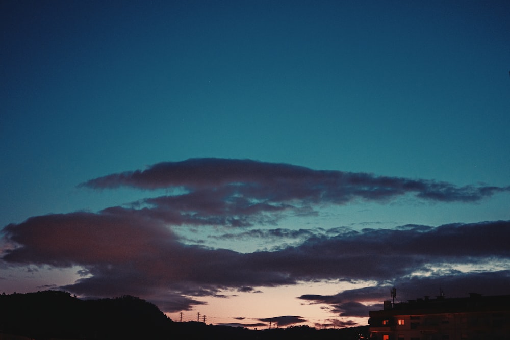 silhouette of buildings under blue sky during sunset