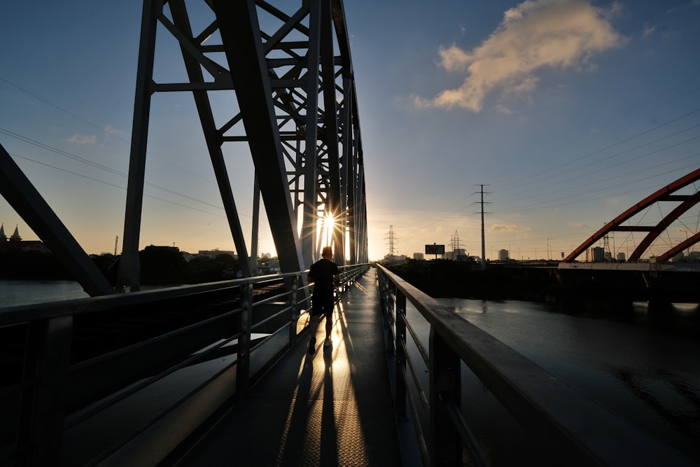 gray metal bridge during sunset