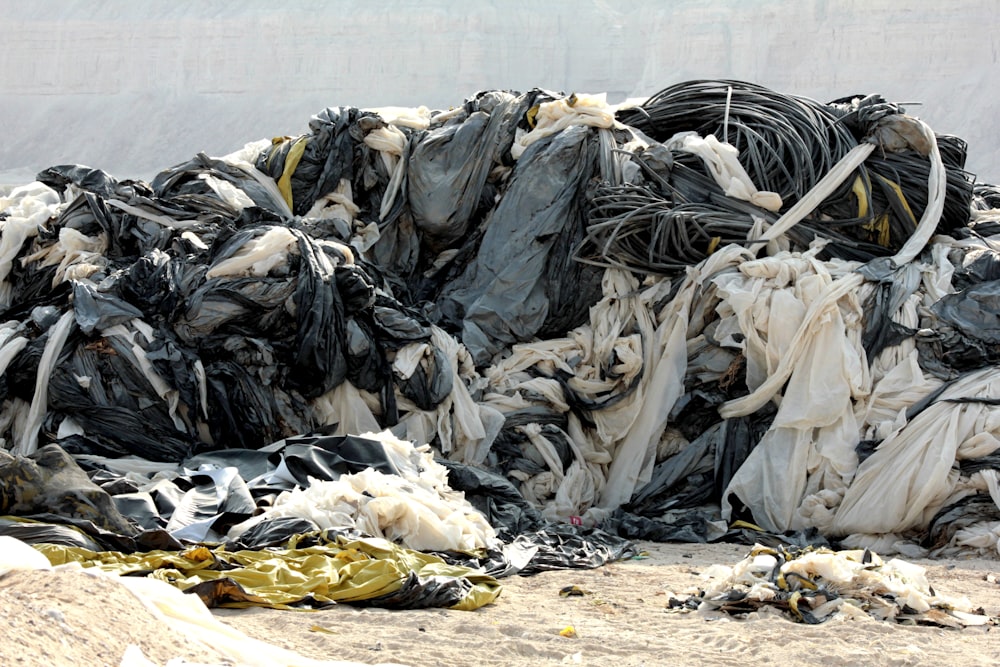 black and white plastic bags on brown sand during daytime