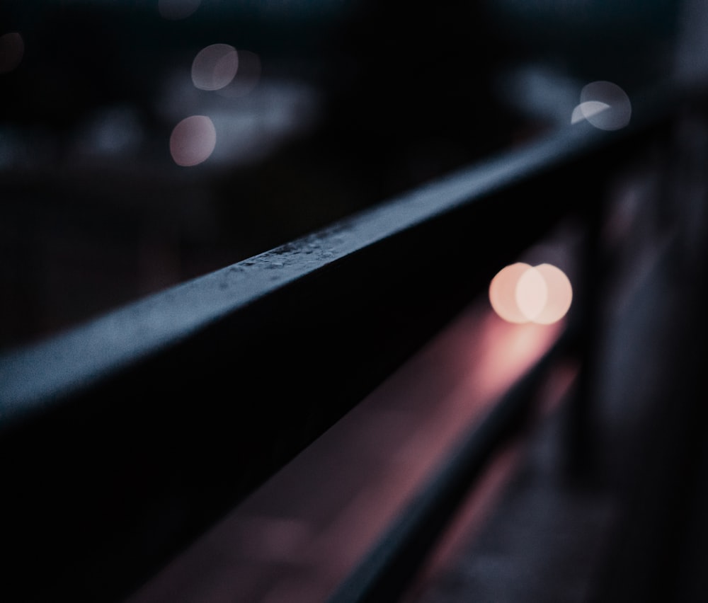 bokeh photography of black metal bar