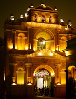 Elegant entrance of Rajvara Grandeur illuminated at dusk, inviting guests with warm golden lights.