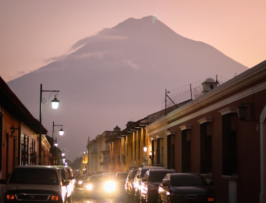 cars parked on side of road near building during night time in Antigua Guatemala Guatemala