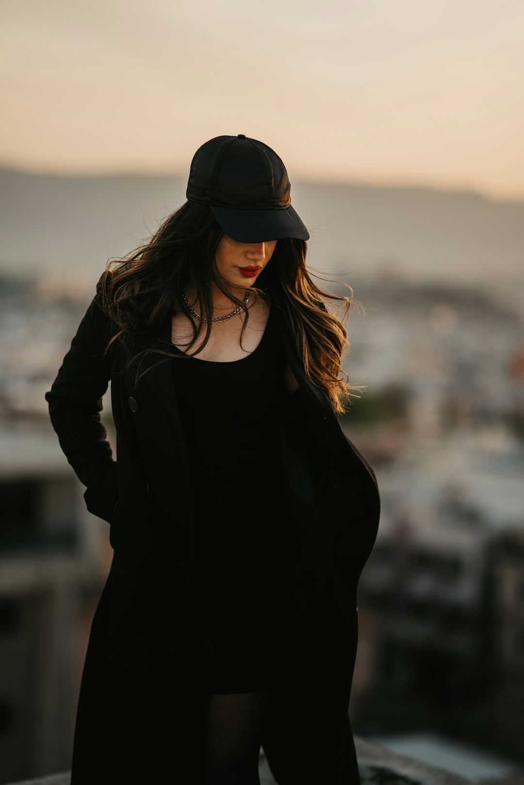 woman in black long sleeve shirt and black hat