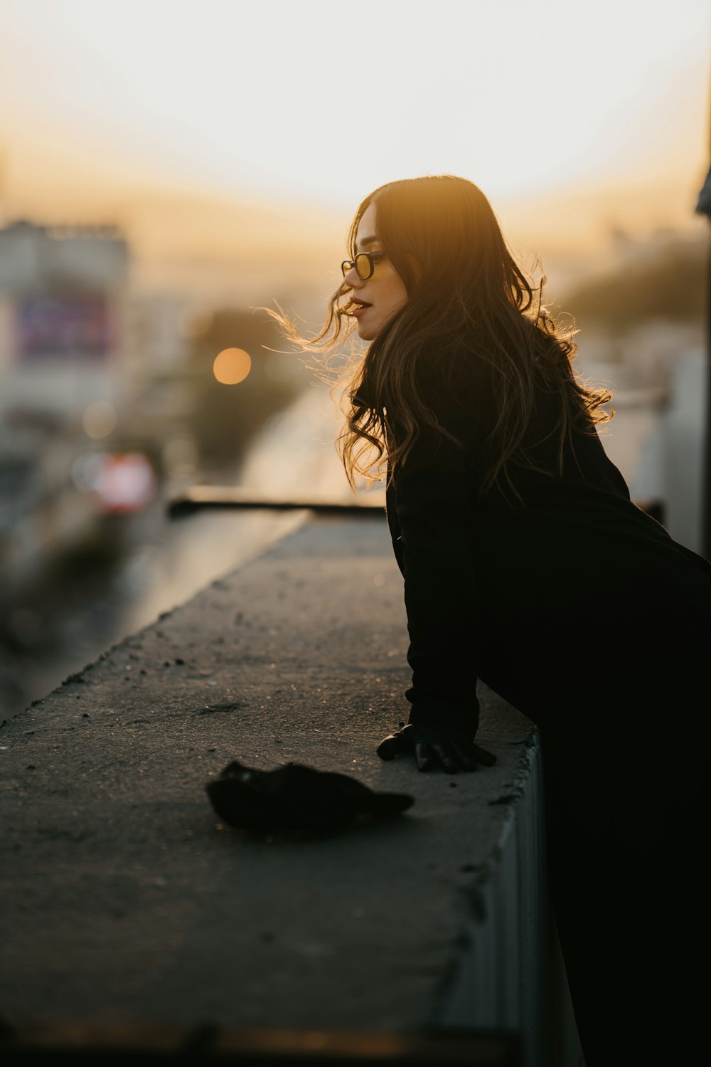 woman in black long sleeve shirt and black pants standing on road during daytime