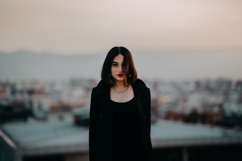 woman in black long sleeve shirt standing on beach during daytime