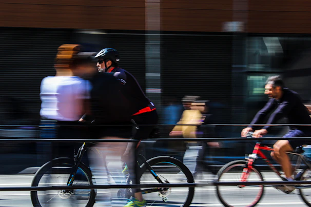 Cyclists commuting through a city intersection during golden hour, capturing motion and energy.