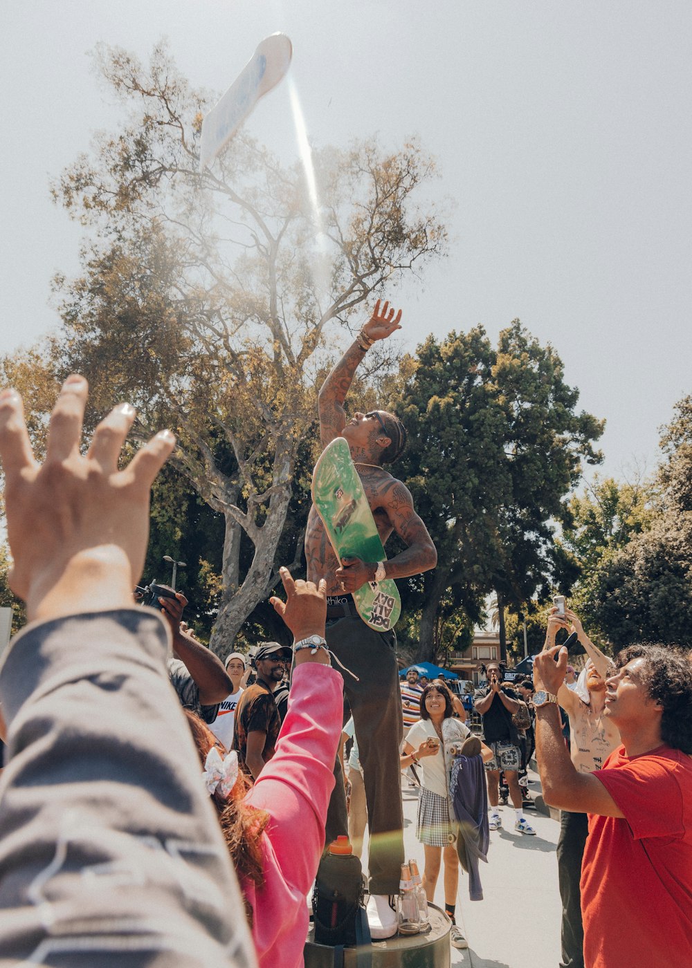 people raising their hands during daytime