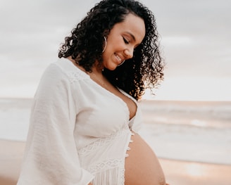 woman in white long sleeve shirt pregnant.