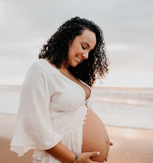 woman in white long sleeve shirt pregnant.