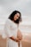 woman in white long sleeve shirt standing on beach during daytime