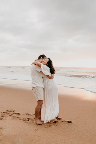 woman in white dress standing on beach during daytime