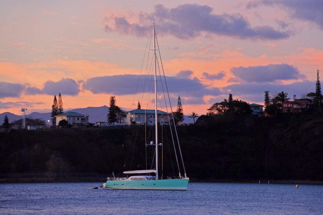 white sail boat on sea during daytime