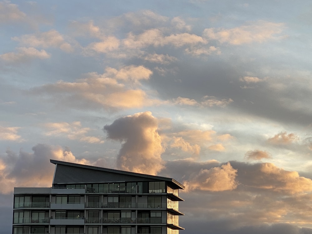 black and white concrete building under white clouds