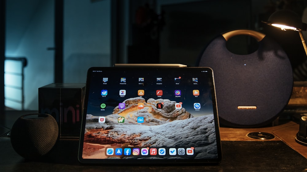 black ipad on brown wooden table