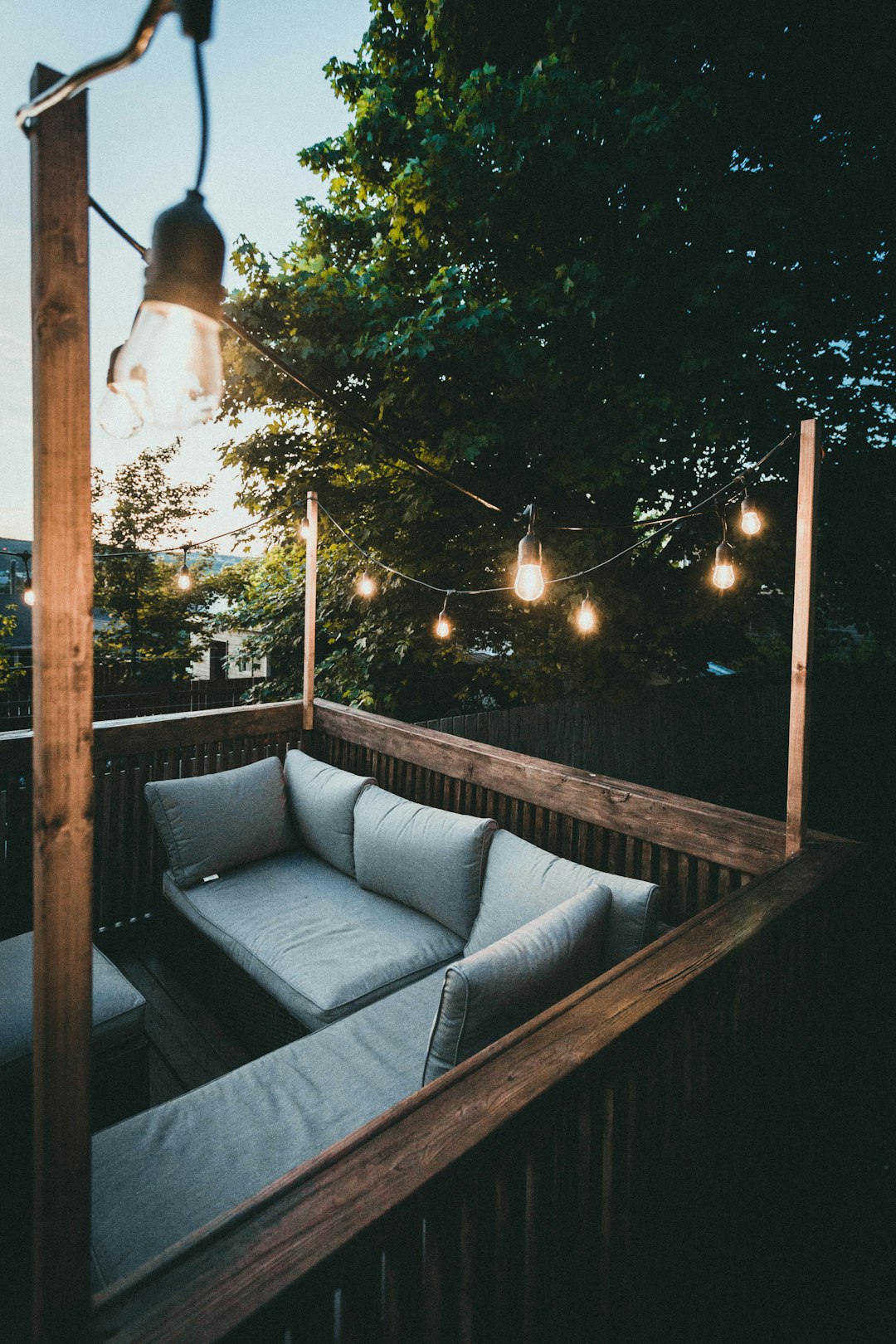 white and gray couch on brown wooden frame