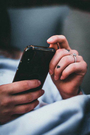 person holding black iphone 5